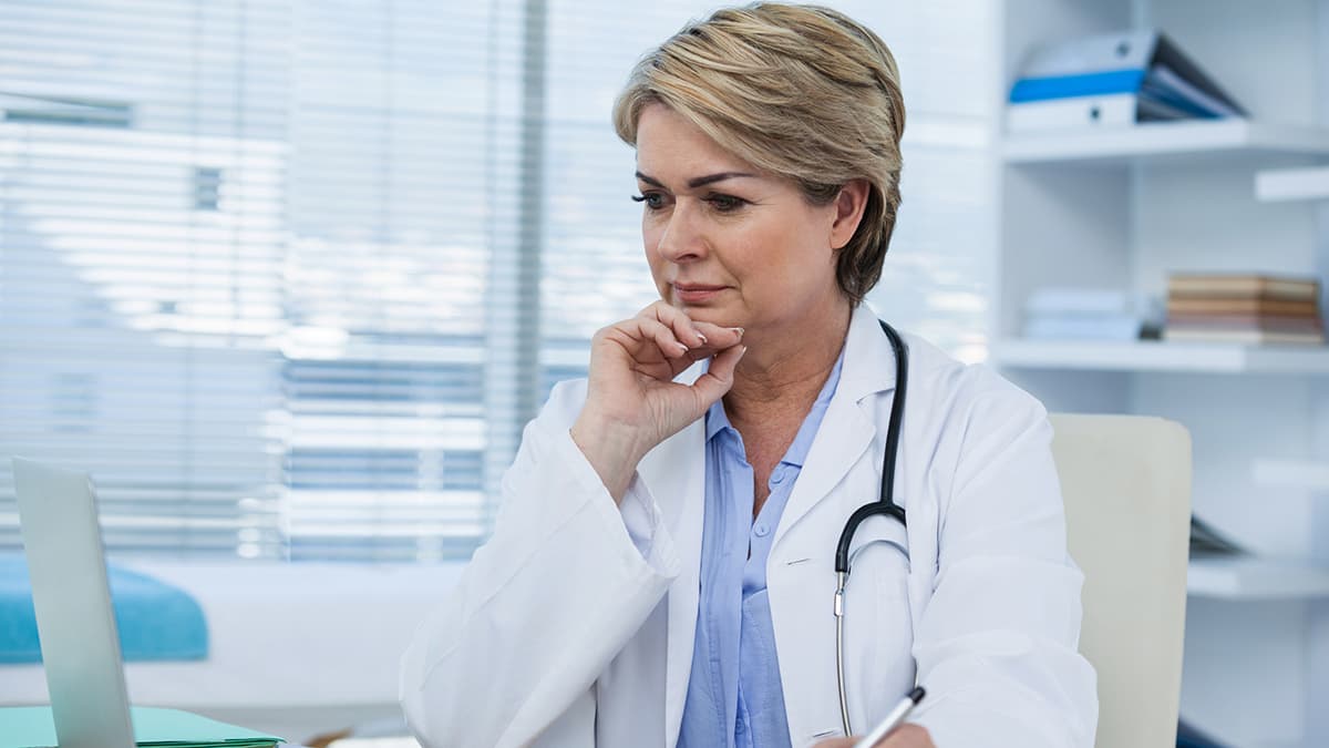 doctor looking at her laptop Doctor looking at her laptop