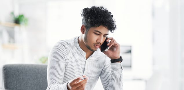 Shot of a young businessman talking on a cellphone while goi&hellip;