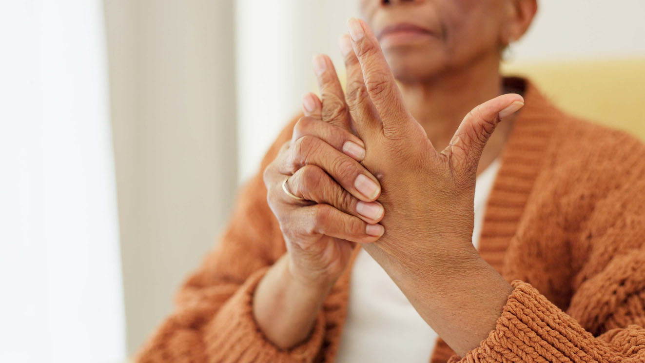 woman holding hand in pain Woman holding hand in pain