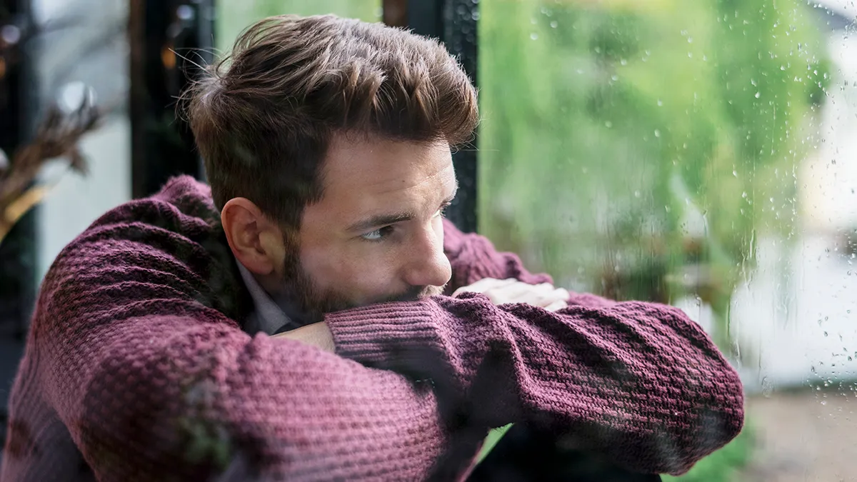 mood-disorders Thoughtful man looking out the window